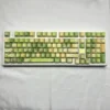 Jasmine Snow Bud PBT Keycap Set on a white mechanical keyboard, showcasing delicate floral designs and translucent side-engraved legends.
