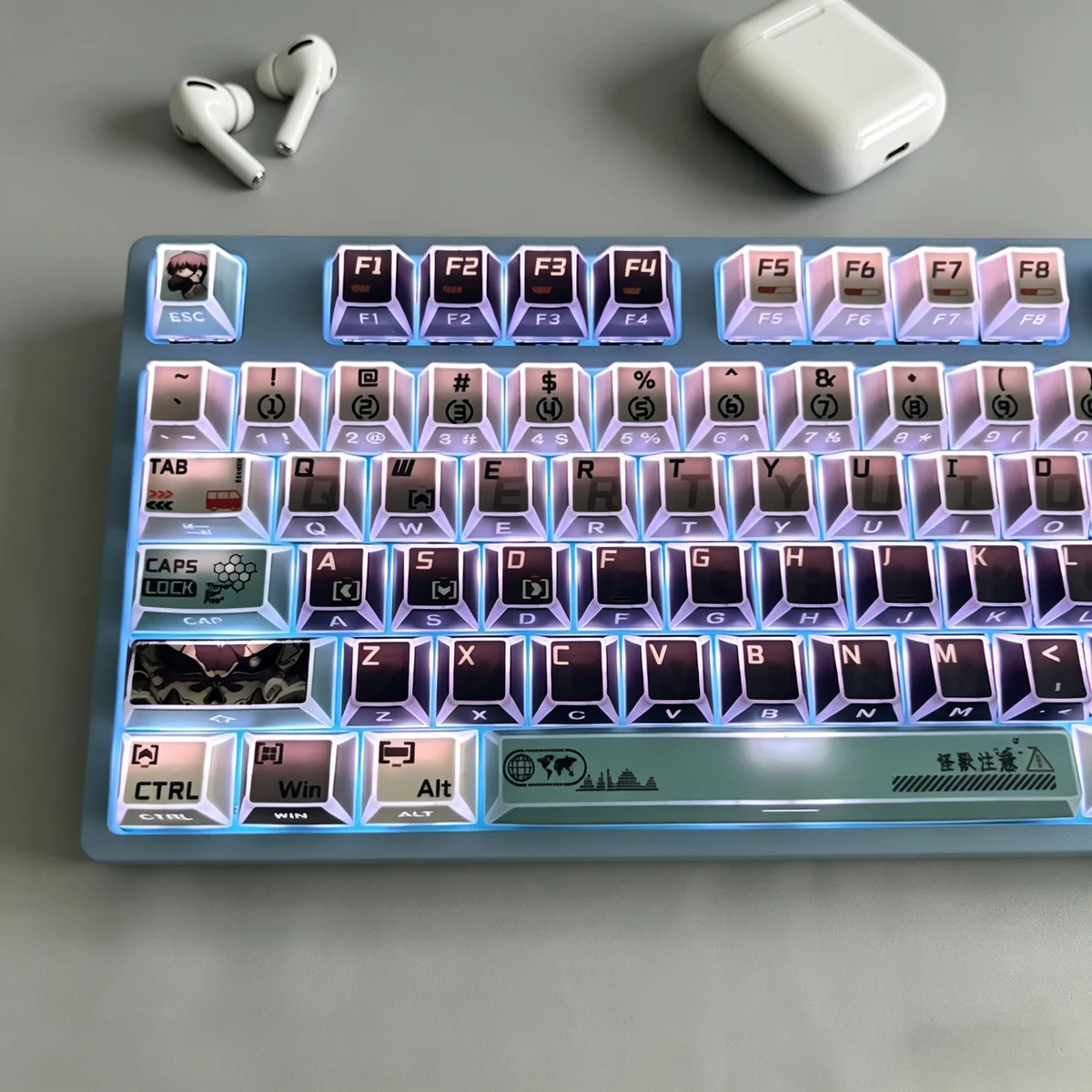 Kaiju No. 8 themed desk setup with keycaps glowing with RGB lighting