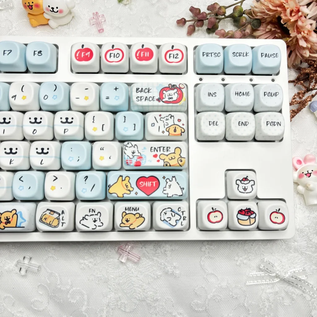 Close-up of Maltese dog and apple illustrations on PBT keycaps