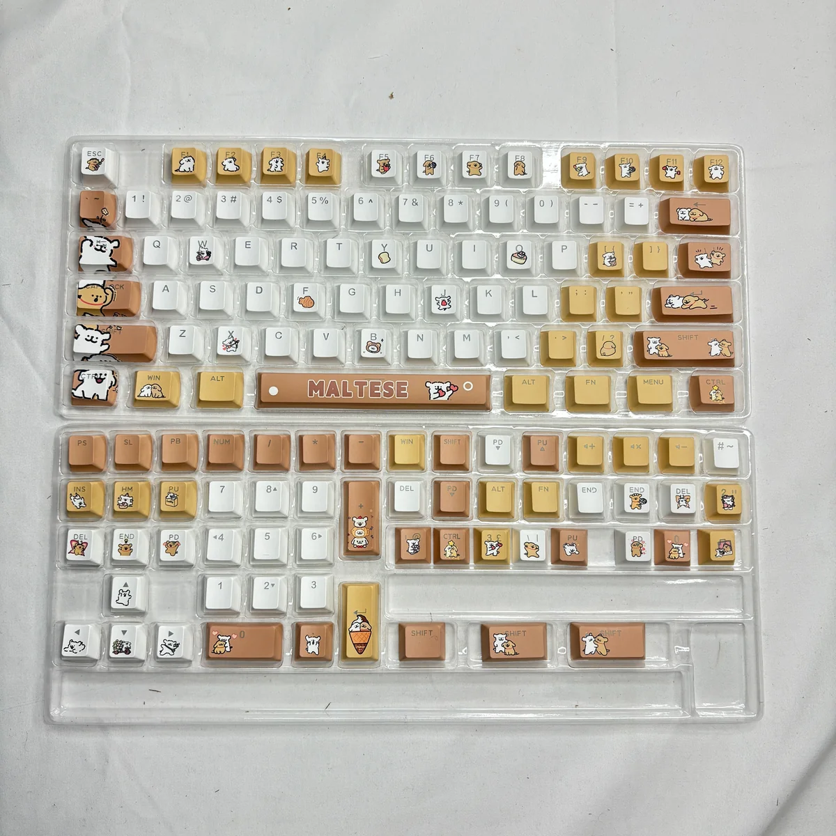 Maltese Dog themed keycaps with various spa-related accent keys
