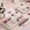 Detailed shot of pink, brown, and cream keycaps from the Chocolate Strawberry set