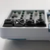 Detail shot of the alloy keycaps texture and the precision of their crafting.