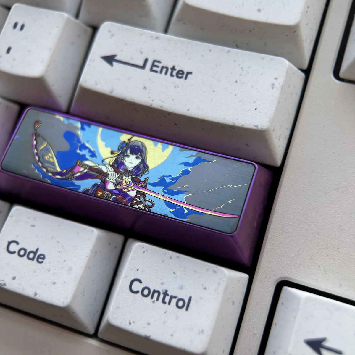 Top-down view of the Raiden Shogun Titanium Artisan Keycap, highlighting its regal design and metallic sheen