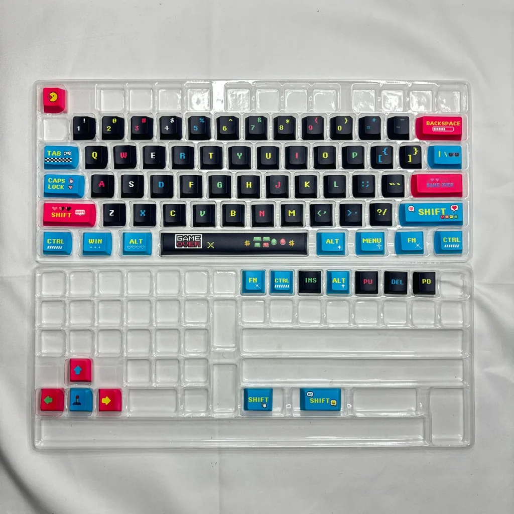 Lifestyle shot of the keycap set in a retro gaming setup, with a matching desk mat and accessories.