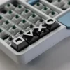 Overhead view of the 4-piece gaming console keycap set, emphasizing their sleek design.