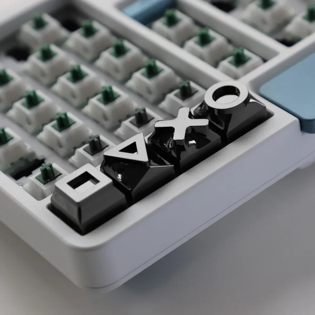 Overhead view of the 4-piece gaming console keycap set, emphasizing their sleek design.