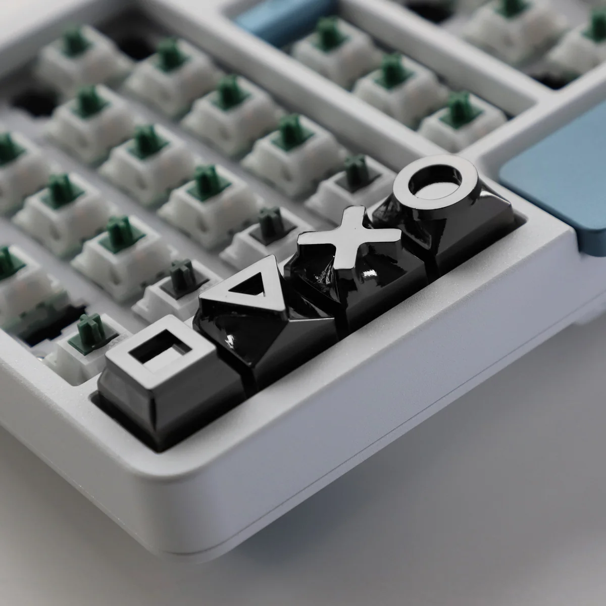 Overhead view of the 4-piece gaming console keycap set, emphasizing their sleek design.