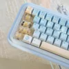 Overhead view of the Summer Kitty Keycap Set on a keyboard, paired with a complementary pastel desk mat, creating a whimsical setup
