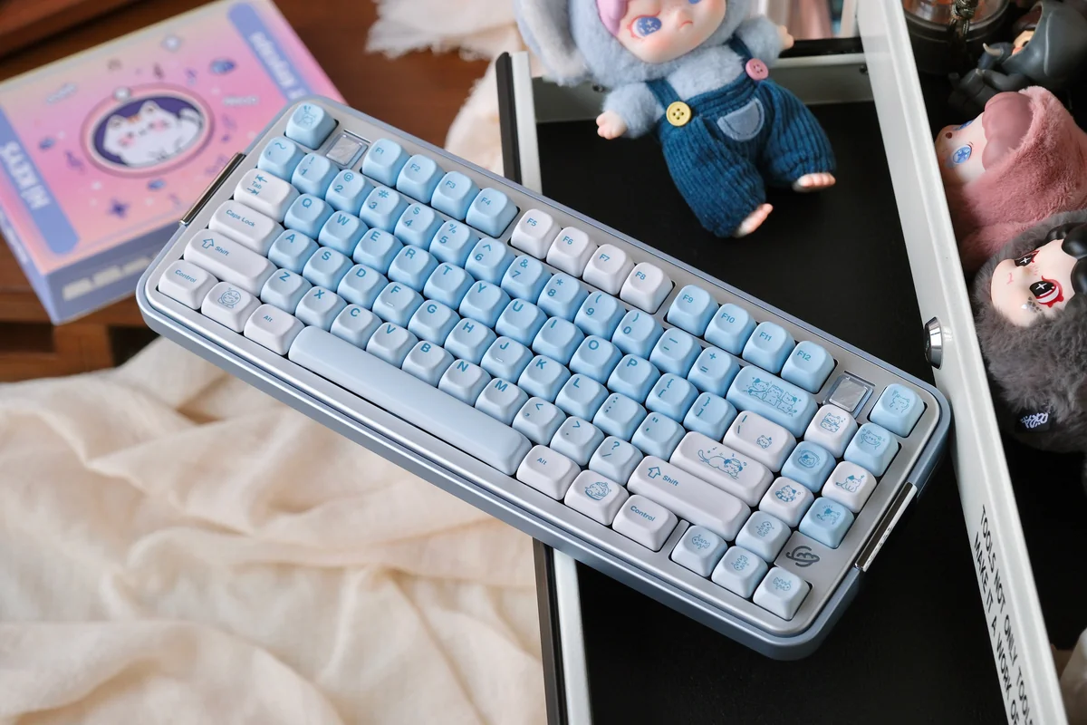 Cluster of Summer Kitty keycaps (e.g., WASD, arrow keys) on a keyboard, illustrating layout coverage and playful design continuity