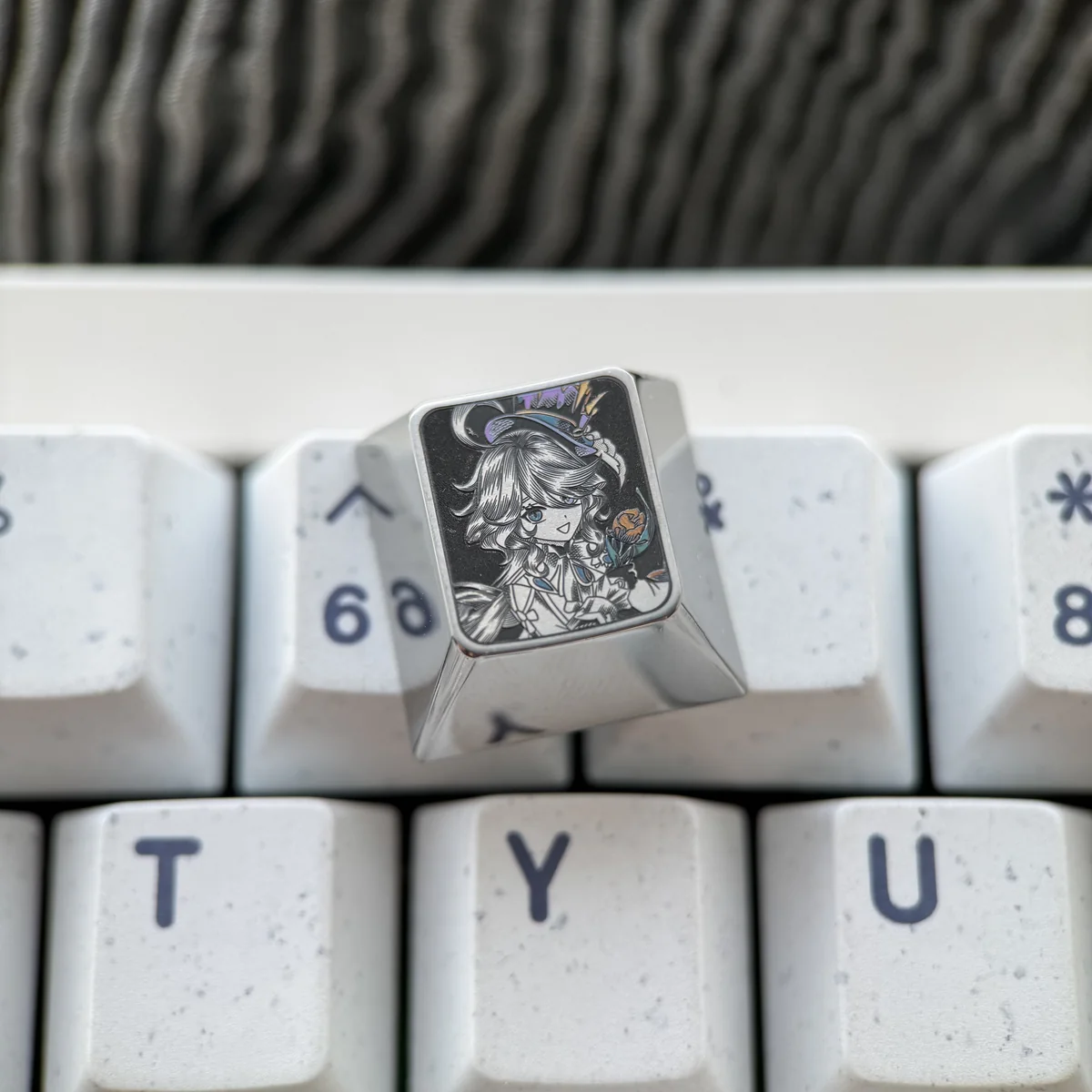 Detail of pointillist engraving on Genshin Impact titanium artisan keycap