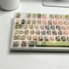 Close-up of Jasmine Snow Bud keycaps, highlighting the PBT texture and unique side-engraved legends with subtle light.
