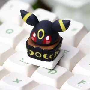 Handcrafted Umbreon Cake Artisan Keycap made of resin, showing Umbreon's face with cake frosting details, on a mechanical keyboard.